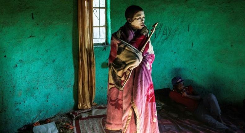 This file photo taken on July 11 shows traditional Xhosa initiate Fezikhaya Tselane, 20 years old, standing during a traditional initiation process in a rural hut in the Coffee Bay area in Umtata, South Africa