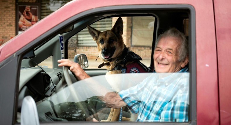 US military veteran Michael Kidd and his companion dog Millie leave after a training session at the Paws of War office in Nesconset, New York -- Millie helps Kidd navigate the difficulties of post-traumatic stress disorder