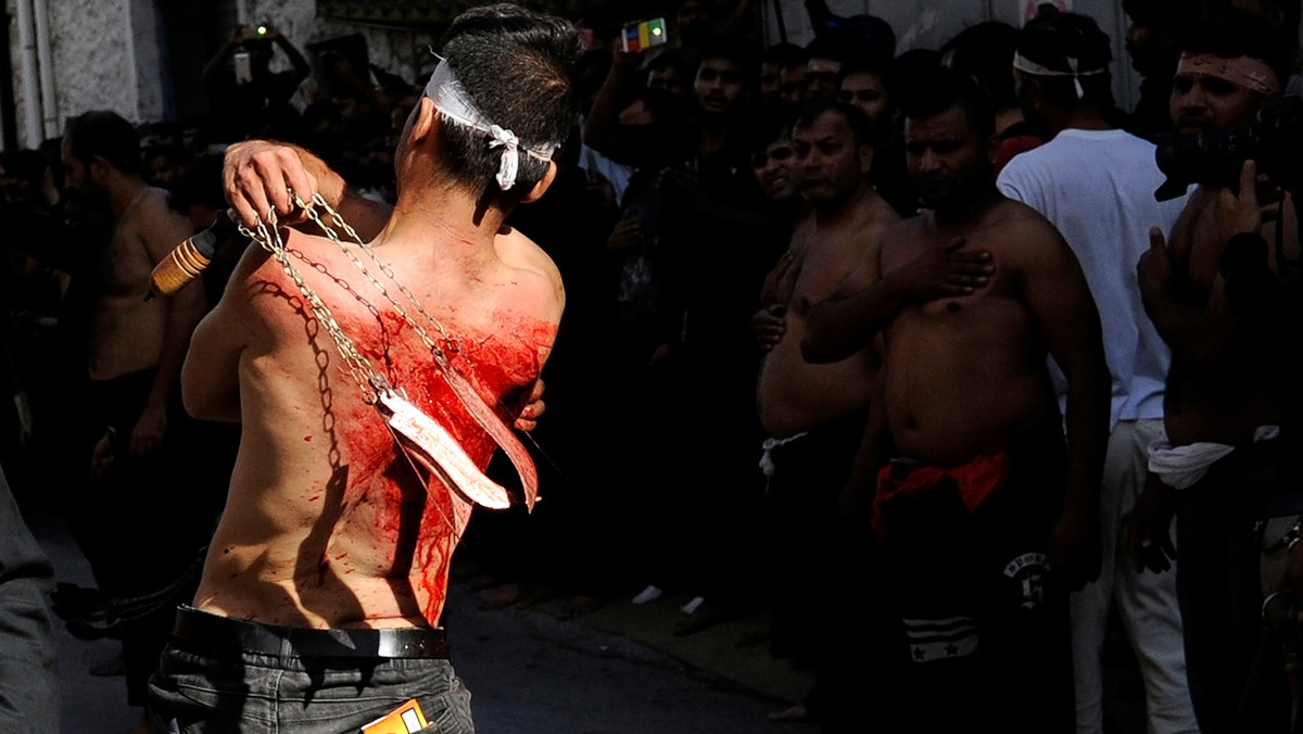 A Shi'ite Muslim living in Greece flagellates himself during a Muharram procession to mark Ashura in Piraeus, near Athens