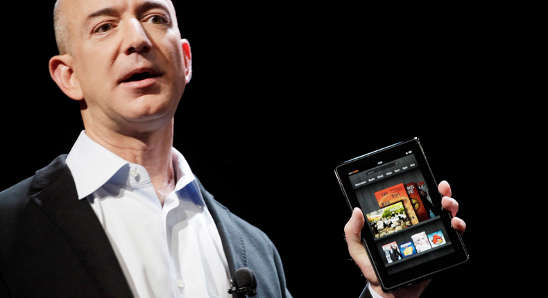 Amazon CEO Jeff Bezos at a previous event, holding one of Amazon's inexpensive Fire tablets.