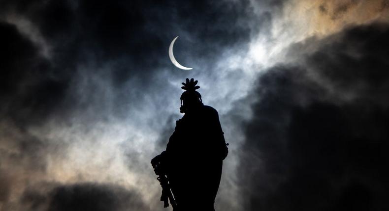 The partial solar eclipse is seen above the Statue of Freedom atop the dome of the US Capitol.Andrew Harnik/Getty Images