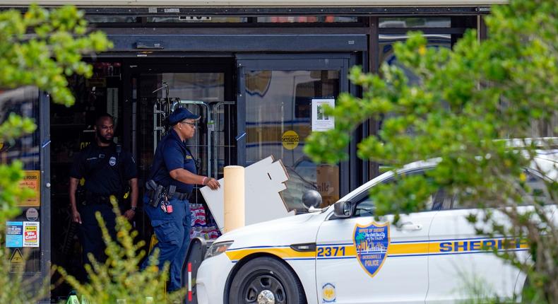 Law enforcement officials remove items from a Dollar General store, Sunday, Aug. 27, 2023 at the scene of a mass shooting, in Jacksonville, Fla.AP Photo/John Raoux