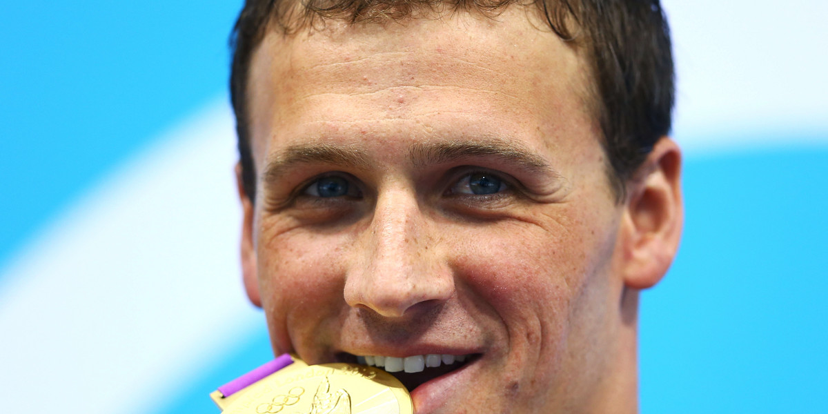 US swimmer Ryan Lochte bites one of his Olympic medals in 2012.