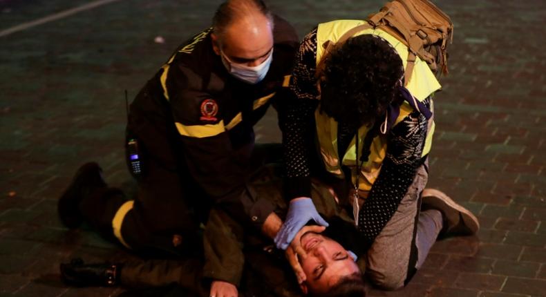 A Lebanese anti-government demonstrator receives first aid following clashes with riot police in the capital Beirut on December 14, 2019.