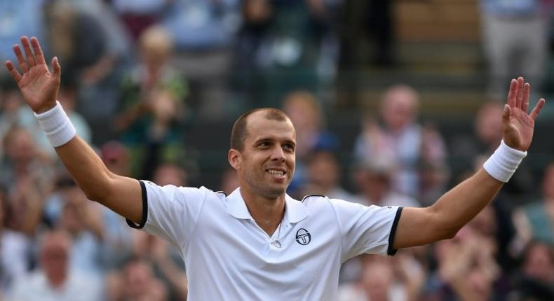 Luxembourg's Gilles Muller acknowledges the Centre Court crowd after beating Spain's Rafael Nadal at Wimbledon on July 10, 2017