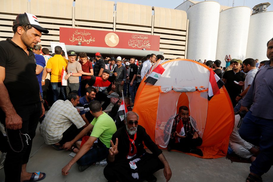 Followers of Iraq's Shiite cleric Muqtada al-Sadr in the parliament building as they storm Baghdad's Green Zone after lawmakers failed to convene for a vote on overhauling the government in Iraq on April 30.