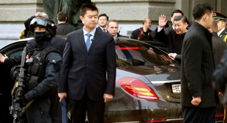 Chinese President Xi Jinping (R) leaves the seat of the Swiss federal parliament in Bern, on January 15, 2017, as part of his state visit