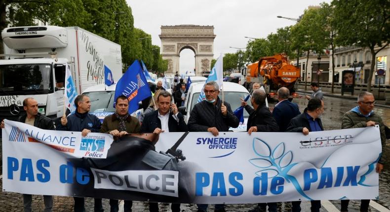 Several dozen police blocked traffic in a wildcat march down the Champs-Elysees avenue in Paris, carrying a banner proclaiming: No police, no peace!