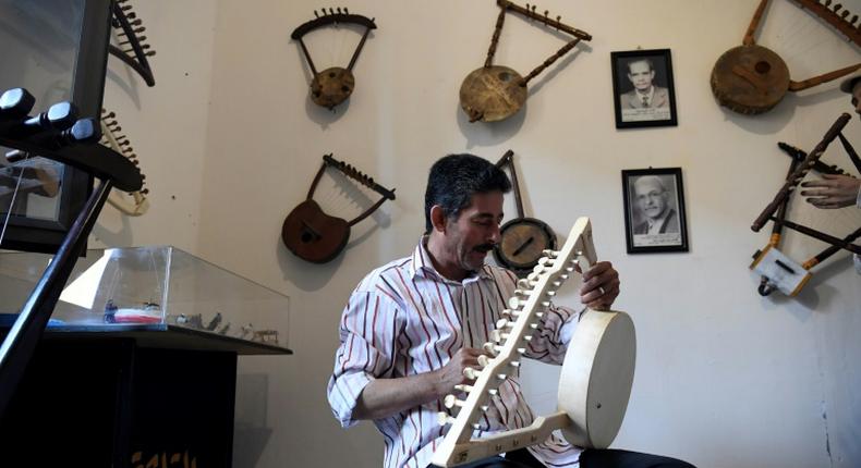 Egyptian craftsman Mohamed Ghaly adds the finishing touches on a semsemia that he made at the Canal 20 cultural museum in Port Said which he founded to pass on the musical heritage to a new generation