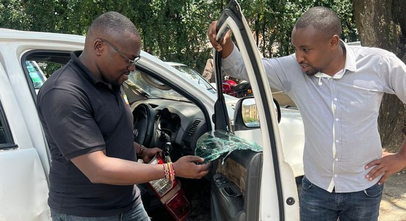 Seth Olale looks at the shattered windows of Citizen TV vehicle