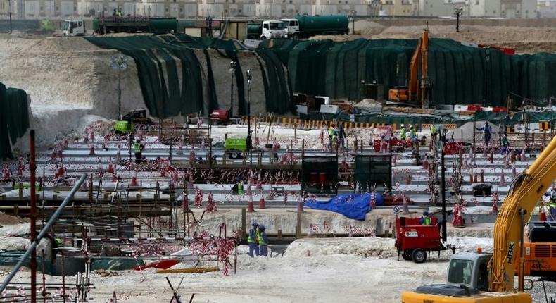 Foreign laborers work at the construction site of the al-Wakrah football stadium in 2015