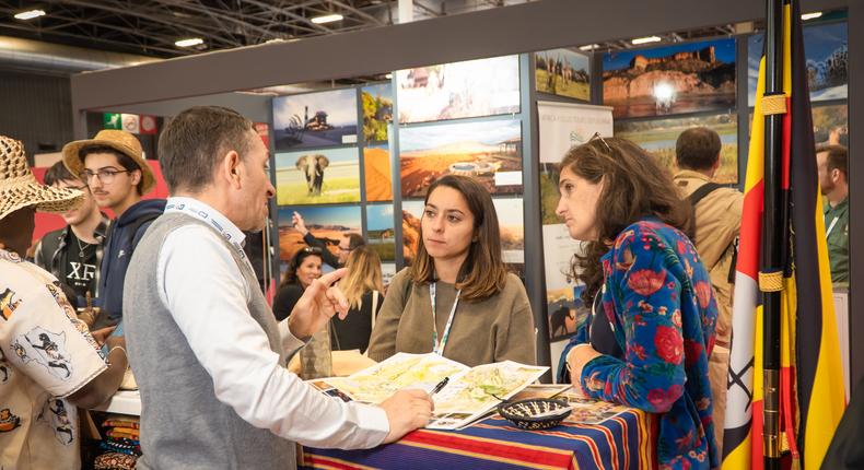 Tourists learning about Uganda at the stand 