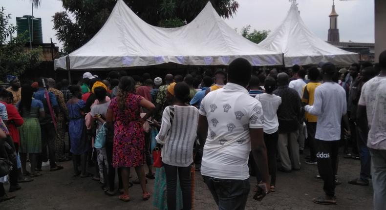 Nigerians queue at the Independent National Electoral Commission (INEC) office in Surulere, Lagos State to collect their permanent voters' cards (PVC)