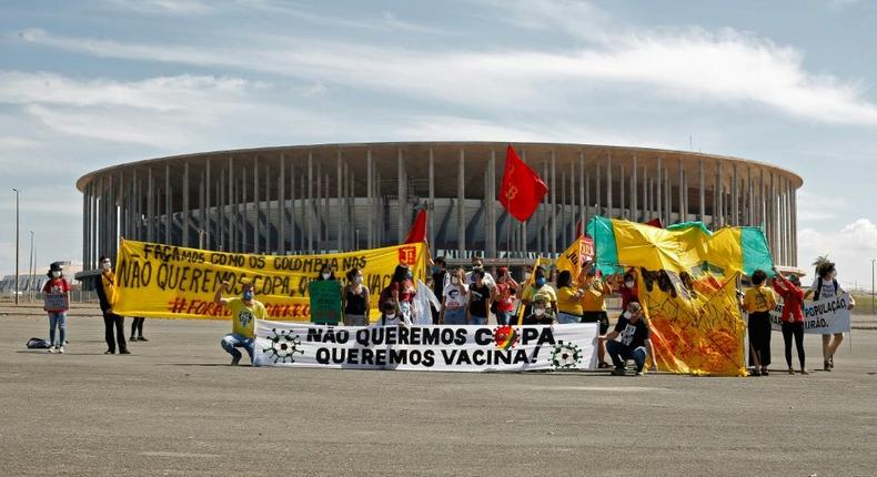 Demonstrators stand behind a banner reading 'We don't want the Copa, we want  vaccines' outside the Mane Garrincha stadium before the Copa America opening game Creator: Sergio Lima