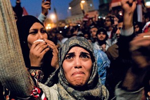 TURNING OF THE TIDE Above: a woman in Cairo’s Tahrir Square in 2011 after President Hosni Mubarak said he would step down.