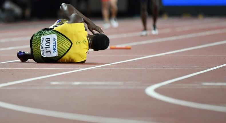 Jamaica's Usain Bolt goes down after pulling up injured in the final of the men's 4x100m relay athletics event at the 2017 IAAF World Championships at the London Stadium in London on August 12, 2017