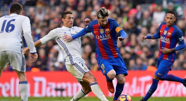 Barcelona's forward Lionel Messi (2ndR) vies with Real Madrid's forward Cristiano Ronaldo on December 3, 2016