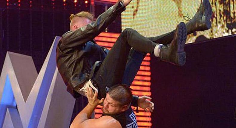 Machine Gun Kelly powerbombed off stage by Kevin Owens