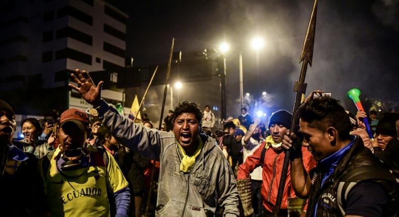 Indigenous people celebrate in Quito on October 13, 2019 after Ecuador's president and indigenous leaders reached an agreement to end violent protests