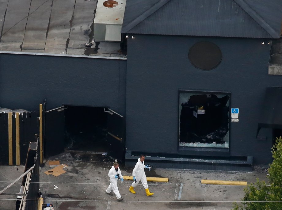 Police forensics investigators work at the crime scene of a mass shooting at the Pulse gay nightclub in Orlando, Florida, on June 12.