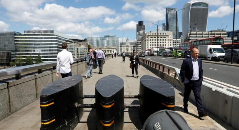 Pedestrians walk pass newly installed barriers on the pavement on London Bridge following the June 3 terror attack in London which killed seven people and injured 48.