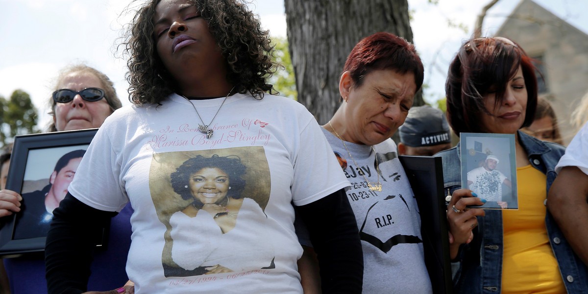 Nortasha Stingiey, second from left, prays with a group of mothers who lost children to gun violence. The group is calling for a stop to shootings in Chicago.