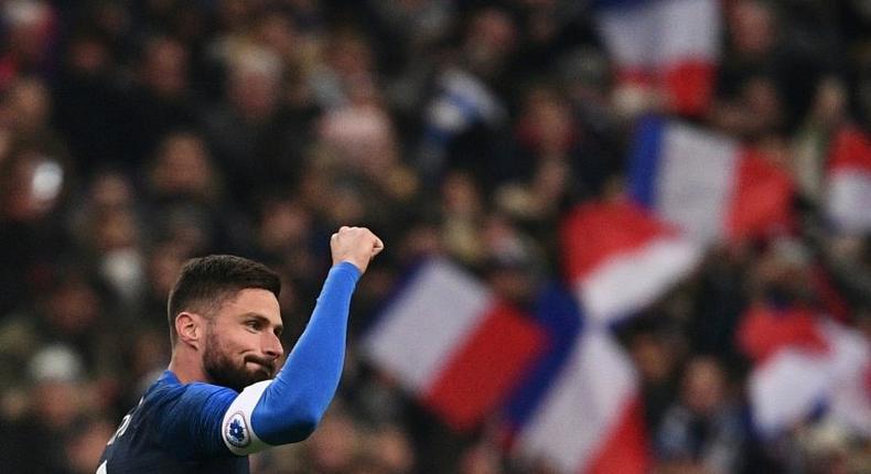 France's forward Olivier Giroud (L) celebrates after scoring a goal against Uruguay