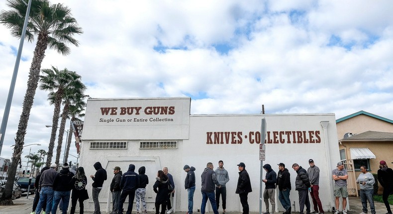 People wait in a line to enter a gun store in mid-March, as gun sales boomed in the early days of the pandemic.