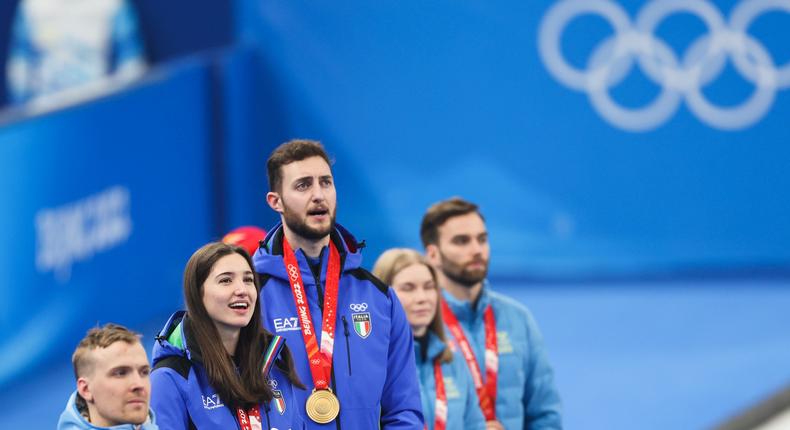 Italy's Stefania Constantini and Amos Mosaner (center) won gold at the mixed double curling event on February 8.