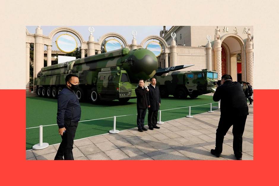 Posetioci u Pekingu pored vojnih vozila naoružanih raketama, među kojima je i hipersonična DF-17 | Foto: Reuters