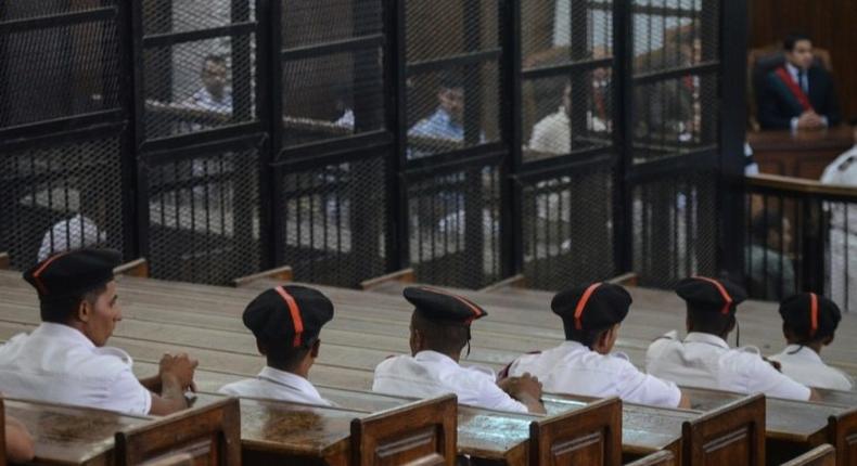 Policemen in court during the trial of 23 people charged over the September killing of police general Nabil Farrag in Kerdassa, considered to be a Muslim Brotherhood stronghold, in Cairo, on June 18, 2014