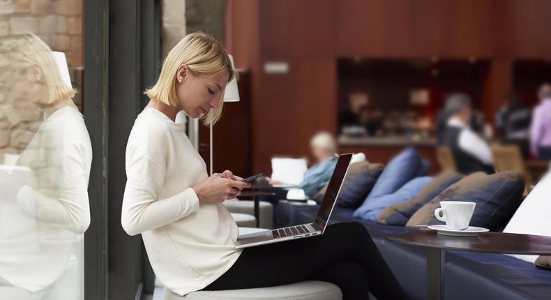 woman texting cafe library laptop