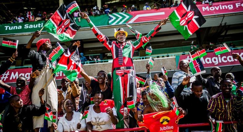 Attendees wave Kenyan flags during the independence celebrations on Jamhuri Day at Kasarani stadium in Nairobi, Kenya, on Tuesday, Dec. 12, 2017. Photographer: Luis Tato/Bloomberg via Getty Images