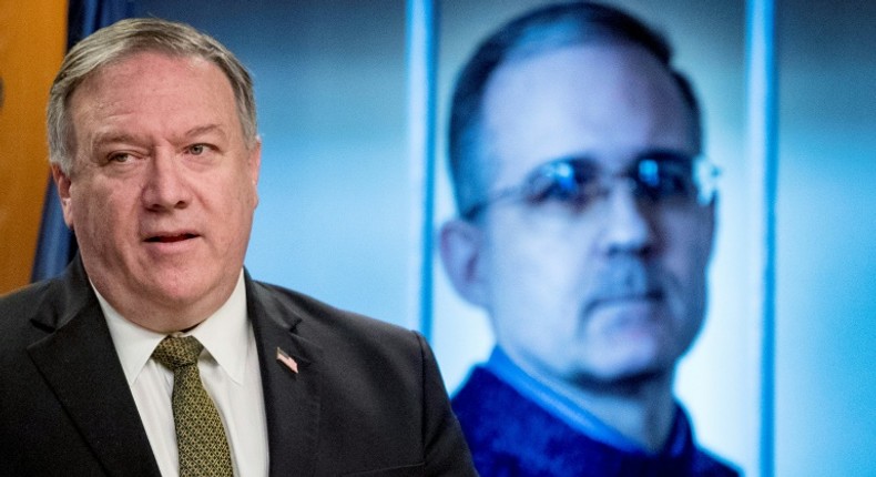 Secretary of State Mike Pompeo stands before an image of former US marine Paul Whelan as he urges his release during a news conference on June 10, 2020