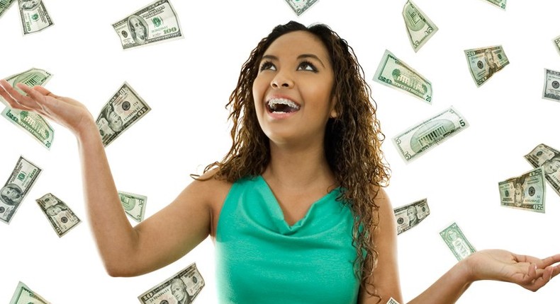 Young woman with money (File Photo)