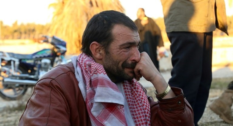 A Syrian evacuated from rebel-held neighbourhoods in Aleppo, cries on arrival at the opposition-controlled Khan al-Aassal region, west of the city