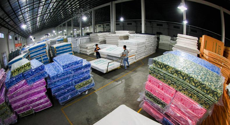 Workers process mattresses at a company in China.VCG/Getty Images