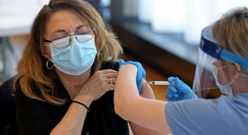 A physician administers the Moderna COVID-19 vaccine.
