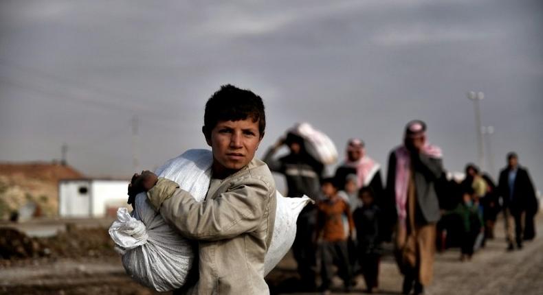 Residents of west Mosul flee the city on March 14, 2017, among more than 150,000 that have been displaced by the offensive government forces launched against the Islamic State group last month