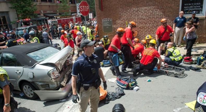 A woman receives first-aid after a car plows into a crowd in Charlottesville, Virginia after a rally by white nationalists turns violent