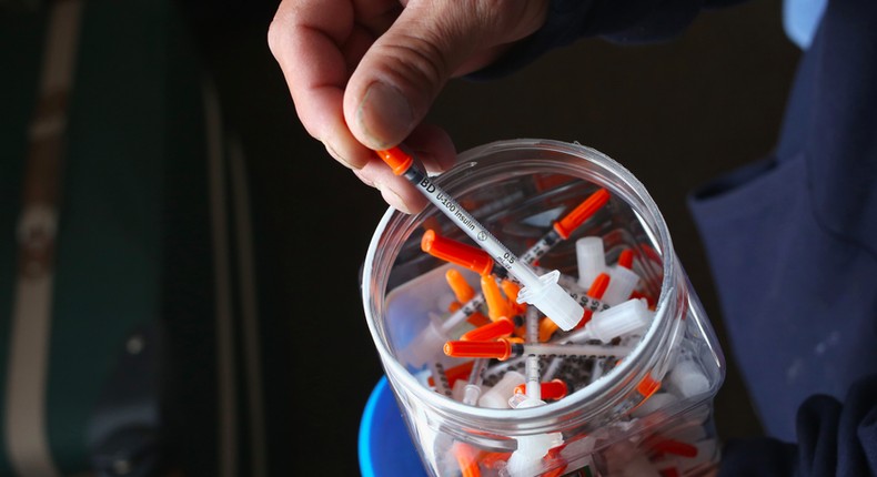 A drug user takes a needle before injecting himself with heroin on March 23, 2016 in New London, CT. Communities throughout New England and nationwide are struggling with the unprecidented heroin and opioid pain pill epidemic. On March 15, the U.S. Centers for Disease Control (CDC), announced guidelines for doctors to reduce the amount of opioid painkillers prescribed nationwide, in an effort to curb the epidemic. The CDC estimates that most new heroin addicts first became hooked on prescription pain medication before graduating to heroin, which is stronger and cheaper.