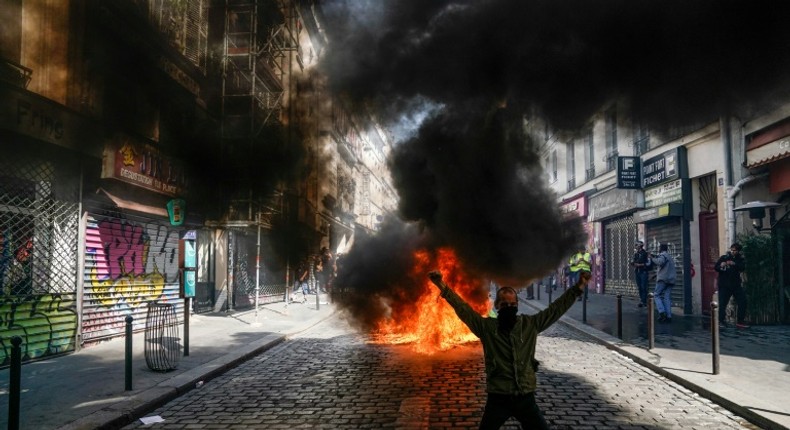 A protester in front of a fire during an anti-government demonstration in Paris