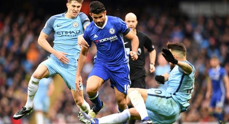 Chelsea's striker Diego Costa (C) vies with Manchester City's defender John Stones (L) and defender Nicolas Otamendi during the English Premier League football match December 3, 2016