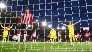 SOUTHAMPTON, ENGLAND - MAY 17: Lyanco of Southampton reacts as Takumi Minamino and Diogo Jota celebrate their sides second goal scored by Joel Matip of Liverpool (not pictured) during the Premier League match between Southampton and Liverpool at St Mary's Stadium on May 17, 2022 in Southampton, England. (Photo by Clive Rose/Getty Images)