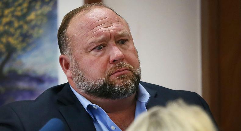 Conspiracy theorist Alex Jones attempts to answer questions about his emails asked by Mark Bankston, lawyer for Neil Heslin and Scarlett Lewis, during trial at the Travis County Courthouse in Austin, Wednesday Aug. 3, 2022.