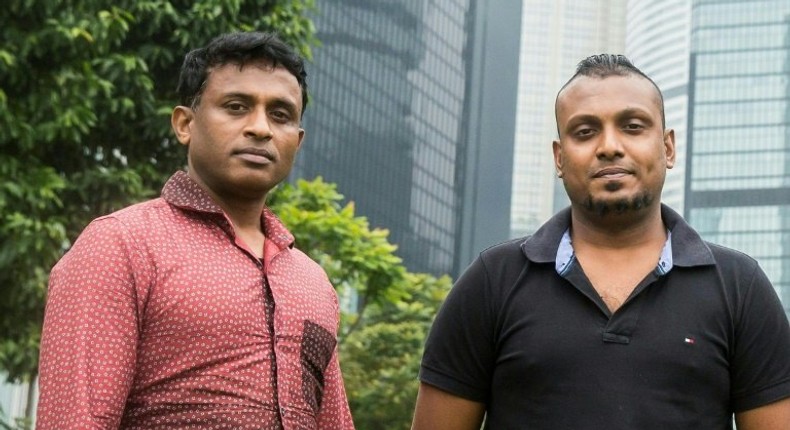 Sri Lankan refugees Ajith Puspa (left) and Supun Thilina Kellapatha pose for a photo in Hong Kong, on February 23, 2017