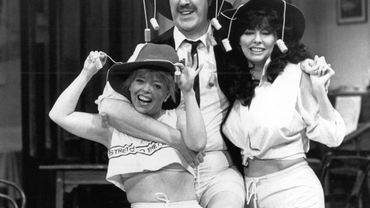 ALLO ALLO ; stage version of TV show, promoting transfer of the production to Australia ; Sue Hodge (as Mimi Labonq) ; Gorden Kaye (as Rene Artois ) ; Vicki Michelle (as Yvette Carte-Blanche) ; at the Palladium Theatre, London, UK ; 11 January 1990 ; Cred