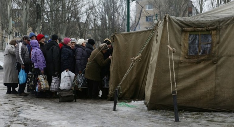 Residents of the war-scarred and cashed-starved Ukraine queue outside a tent to get warm clothes in Avdiivka, Donetsk region, on February 5, 2017