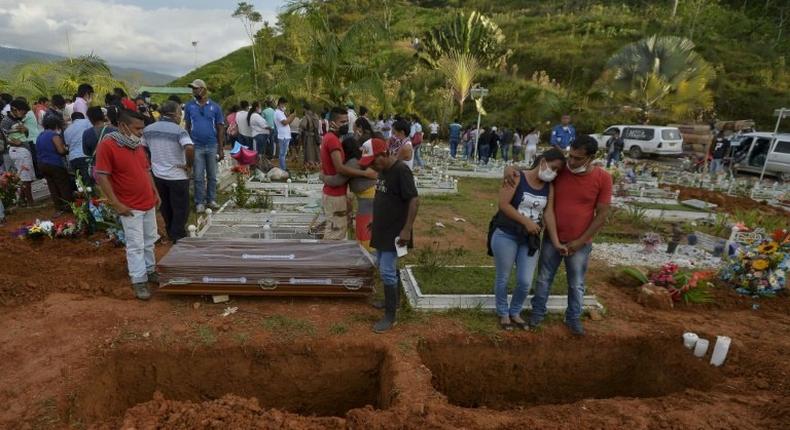 People attend the mass funeral of vistims of a mudslide caused by heavy rains, at the cemetery in Mocoa, Putumayo department, Colombia on April 3, 2017