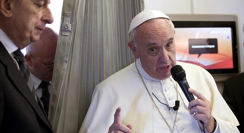 Pope Francis gestures as he talks with journalists during his flight from Manila to Rome